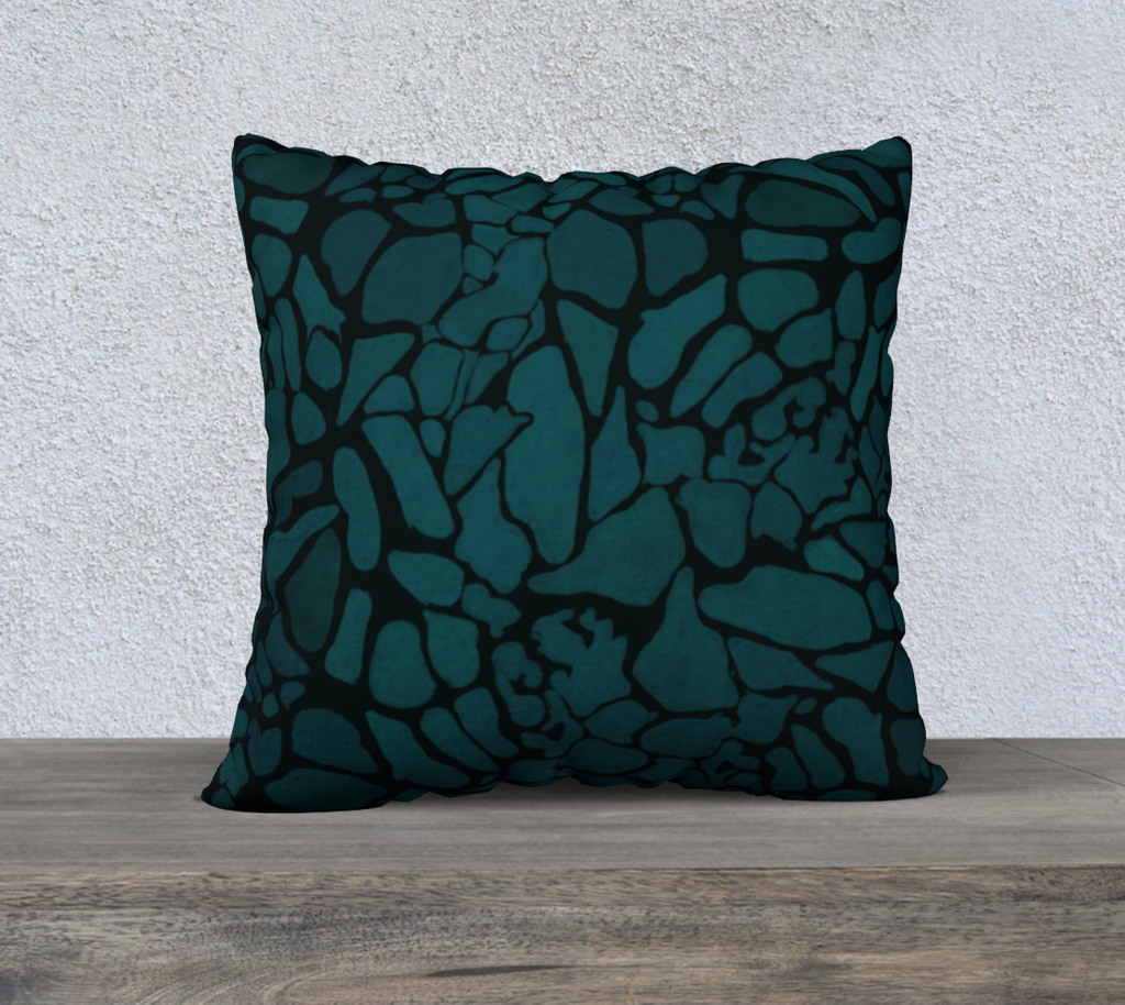 Decorative pillow with abstract pattern on a wooden surface and light gray wall background