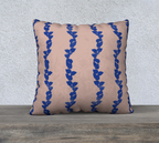 Decorative pillow with blue leaf pattern on a beige background