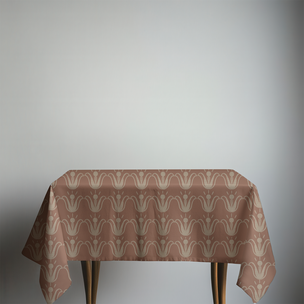 Table with a patterned tablecloth on a plain background