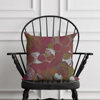 marblized pillow on a black chair against a white paneled wall