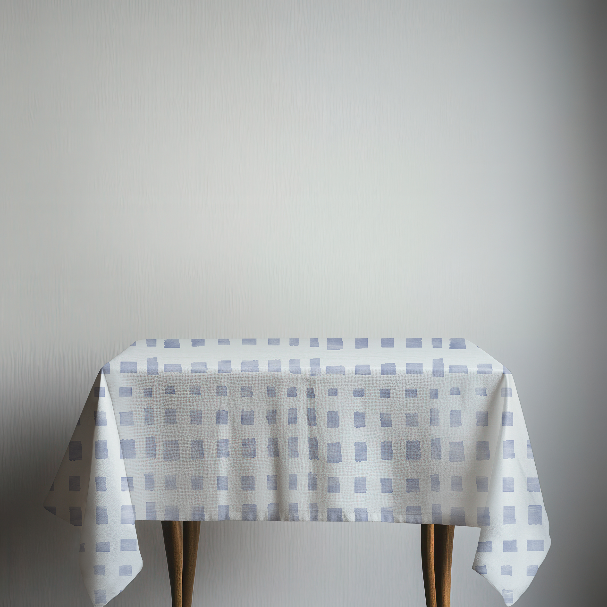 Table with a checkered tablecloth on a plain background