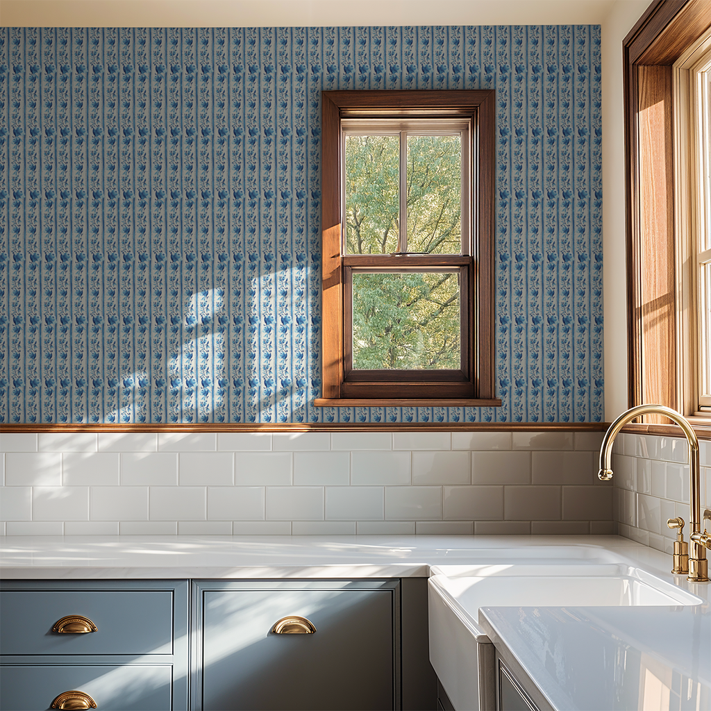 Blue floral watercolor wallpaper in a kitchen with wooden window frame and white tiles.