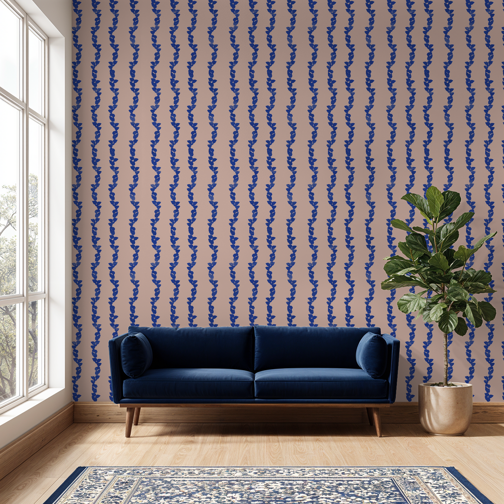 Blue sofa in a room with blue and pink patterned wallpaper