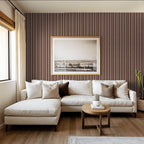 Maroon striped wallpaper in elegant living room with white sofa and framed art.