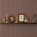 Maroon striped wallpaper with vintage decor on a shelf, creating a warm, elegant ambiance.